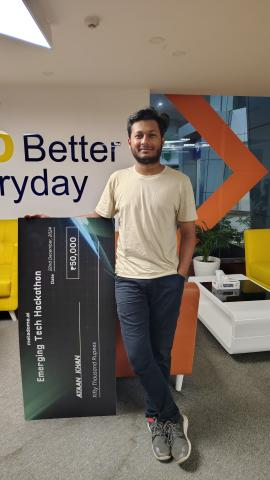 Ayaan Khan holding the Metadome.ai Emerging Tech Hackathon prize cheque